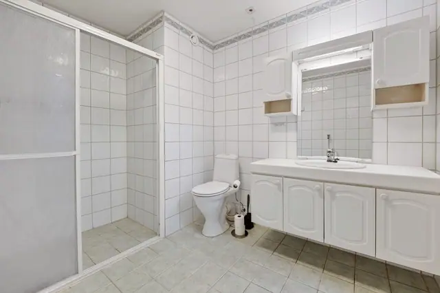 Badet er utstyrt med blant annet dusjnisje, toalett og servantinnredning.